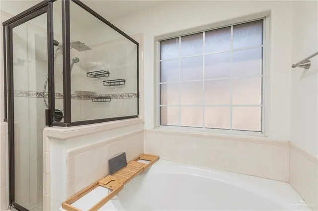 an empty room with a window and a ceiling fan