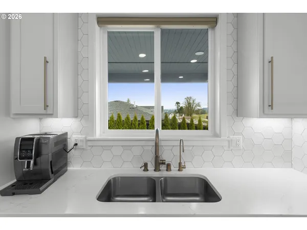 a bathroom with a tub sink and mirror