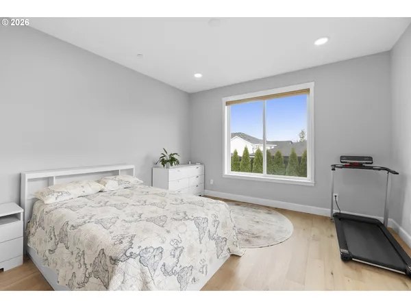 a bedroom with a bed and a large window