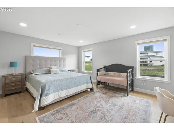 a spacious bedroom with a bed and a window