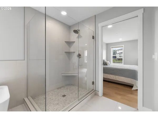 a bathroom with a shower and a sink