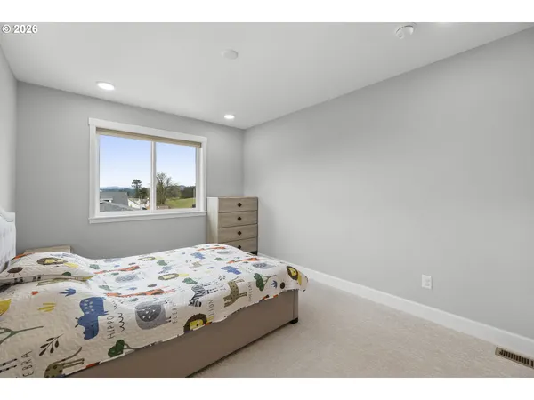 a bedroom with a bed and a dresser