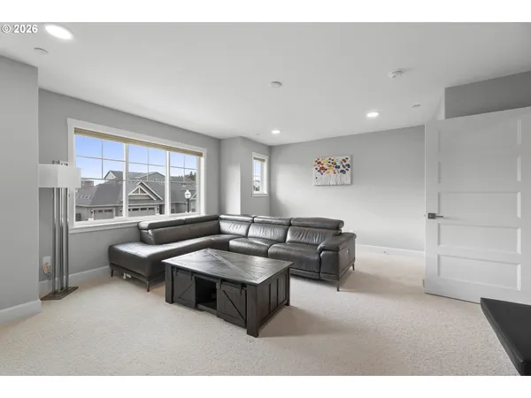a living room with furniture and a floor to ceiling window