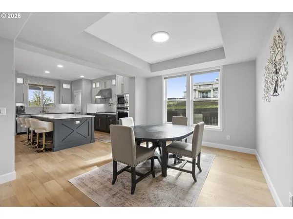 a view of a dining room with furniture and a window