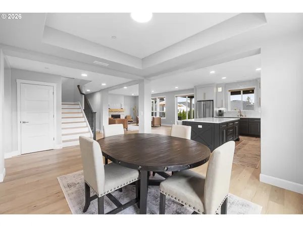 a dining room with furniture and wooden floor