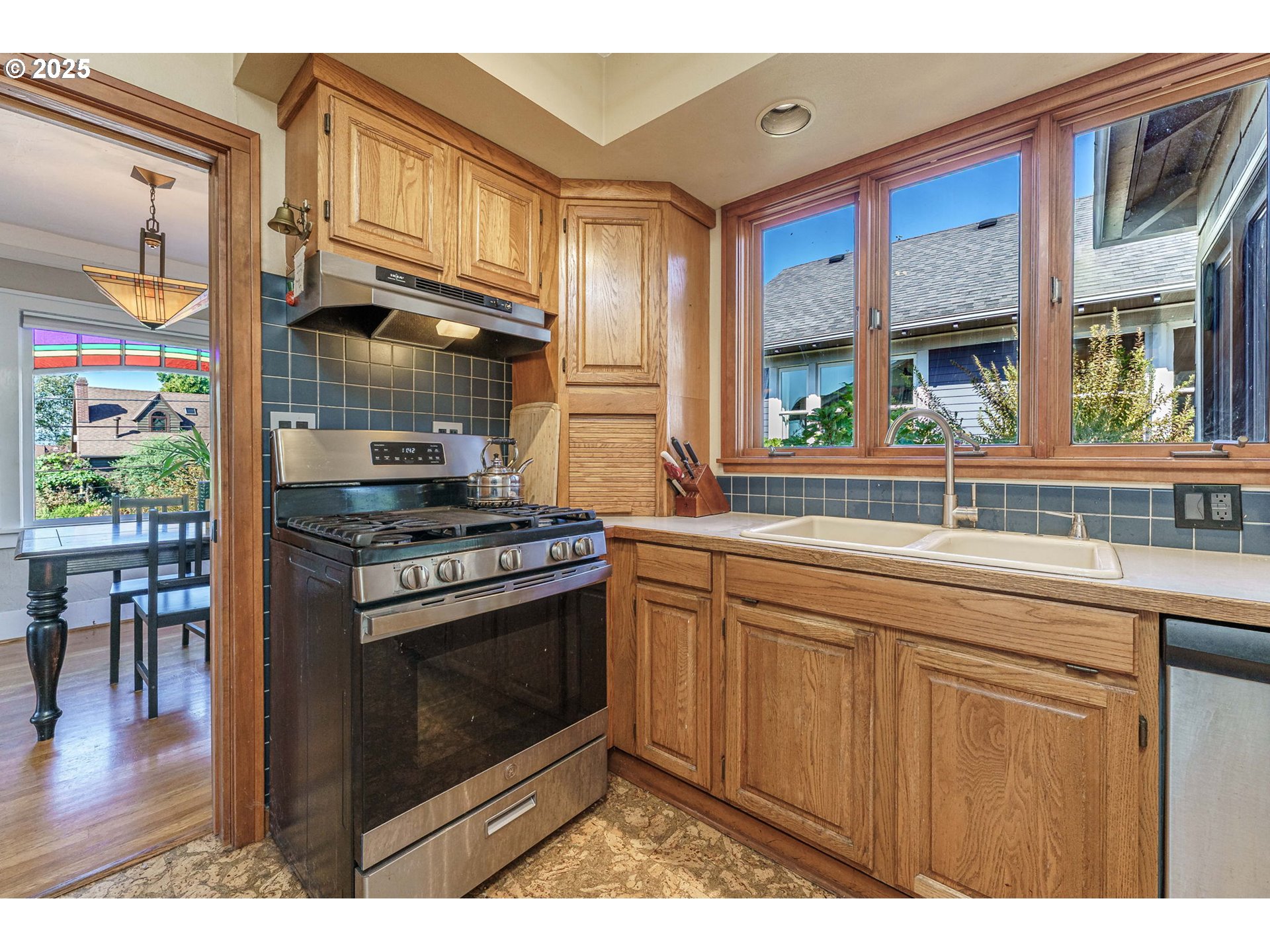 4216 Northeast 18th Avenue Portland, OR 97211 - Photo 12 of 46 a kitchen with stainless steel appliances granite countertop a stove a sink and a microwave