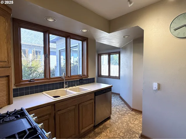 a kitchen with a sink and wooden cabinets
