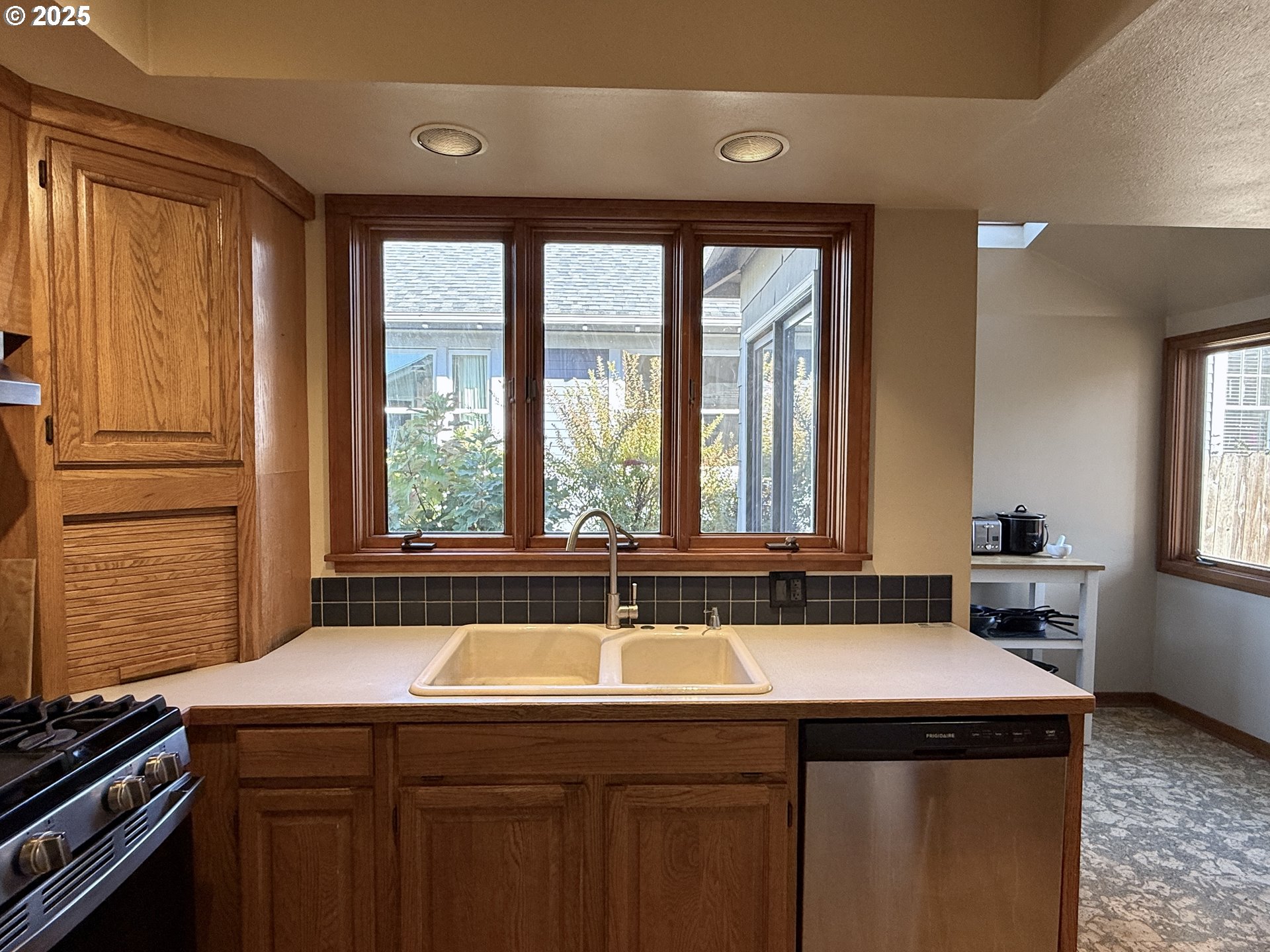 4216 Northeast 18th Avenue Portland, OR 97211 - Photo 14 of 46 a kitchen with a sink and wooden cabinets