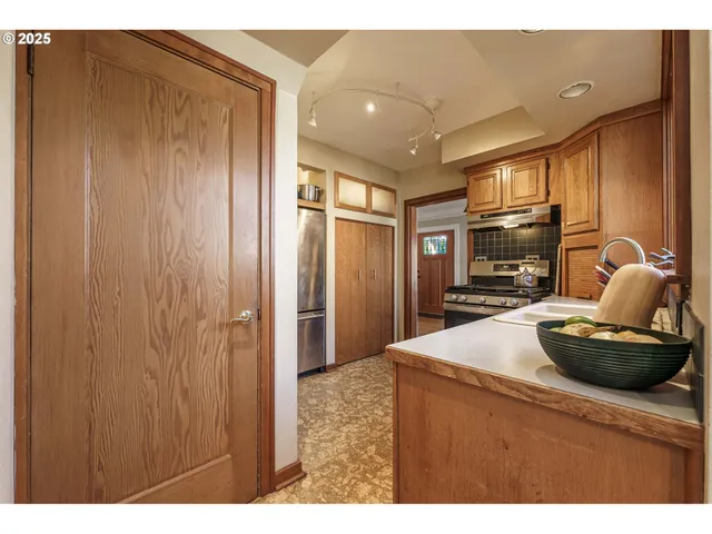a kitchen with stainless steel appliances granite countertop a refrigerator stove and microwave