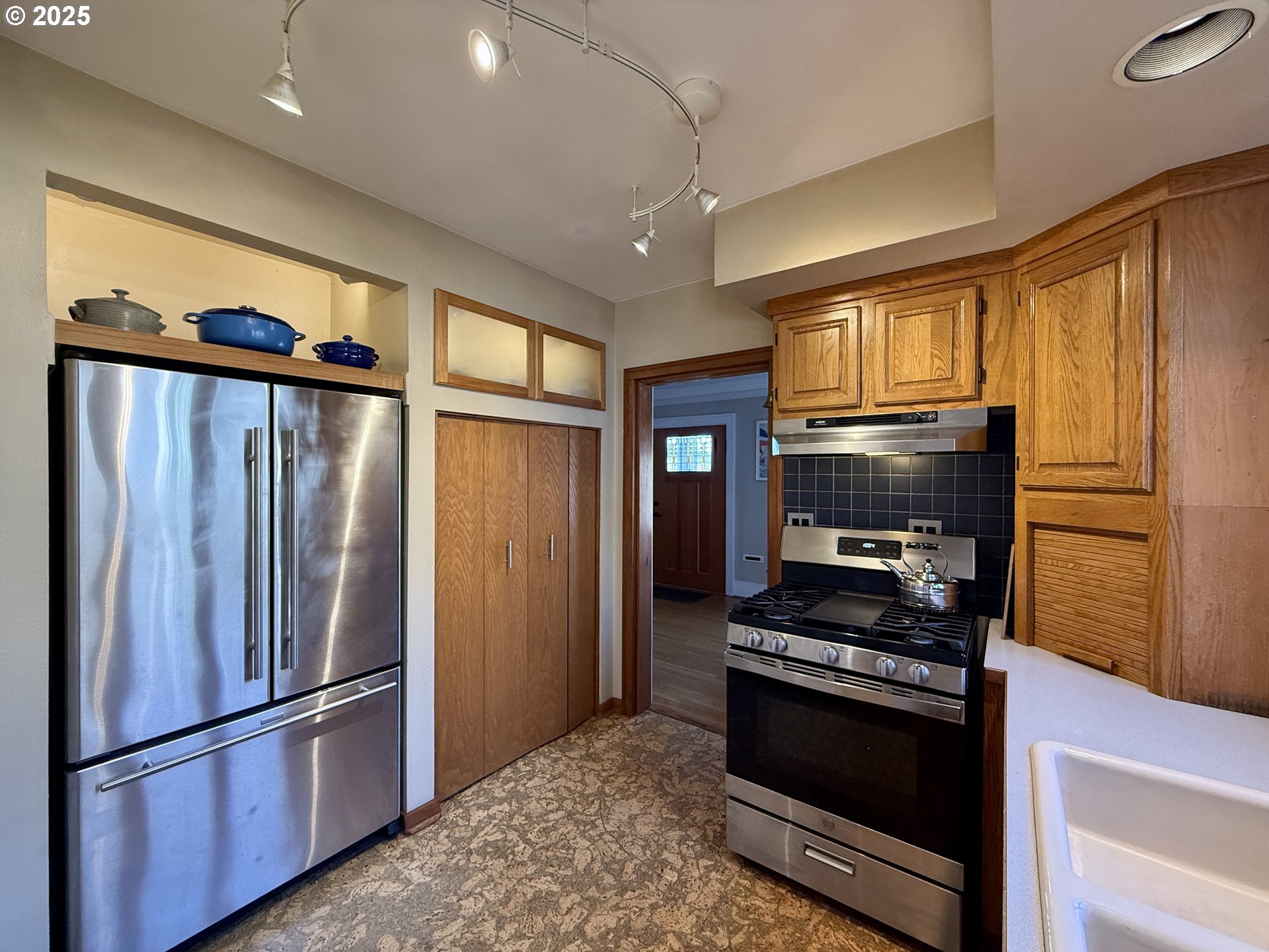 4216 Northeast 18th Avenue Portland, OR 97211 - Photo 17 of 46 a kitchen with stainless steel appliances granite countertop a refrigerator stove and microwave