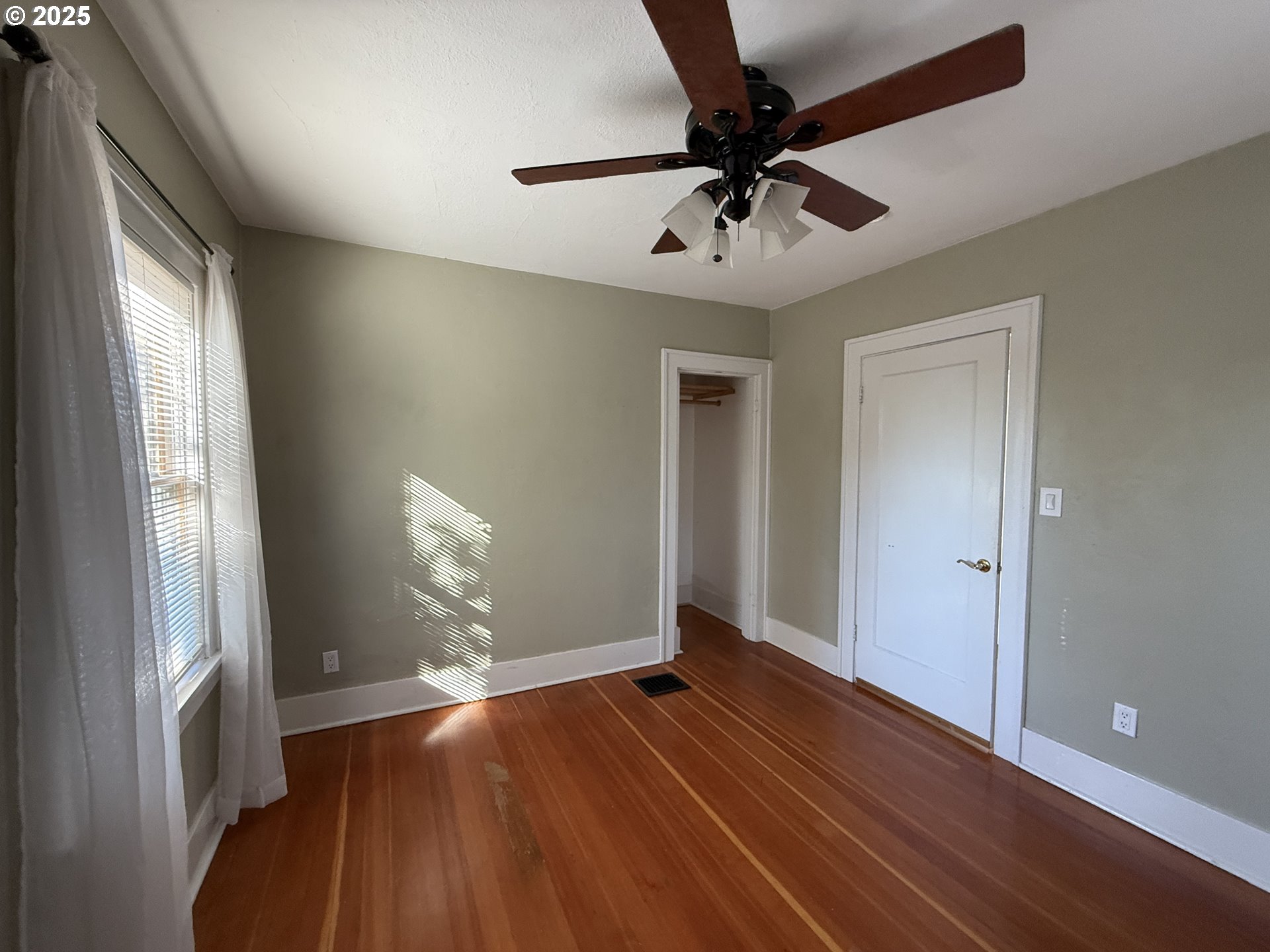 4216 Northeast 18th Avenue Portland, OR 97211 - Photo 19 of 46 a view of empty room with wooden floor and fan