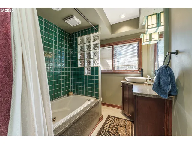 a kitchen with a sink a window and cabinets