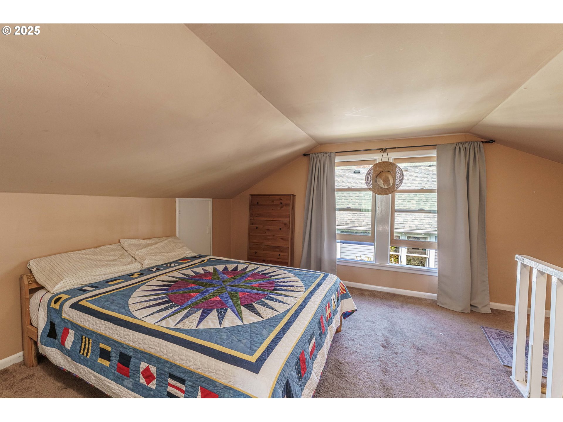 4216 Northeast 18th Avenue Portland, OR 97211 - Photo 25 of 46 a living room with a bed furniture and a window