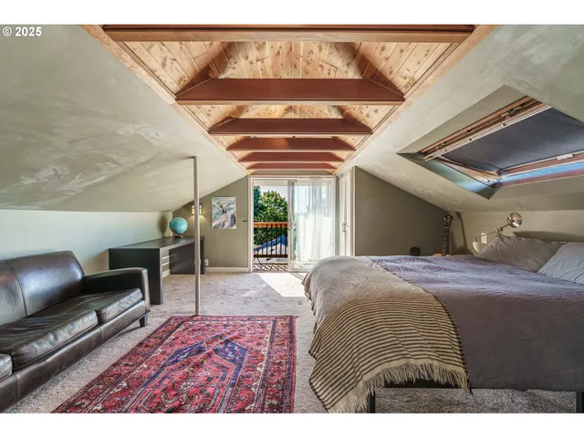 a bedroom with a bed window and lamp