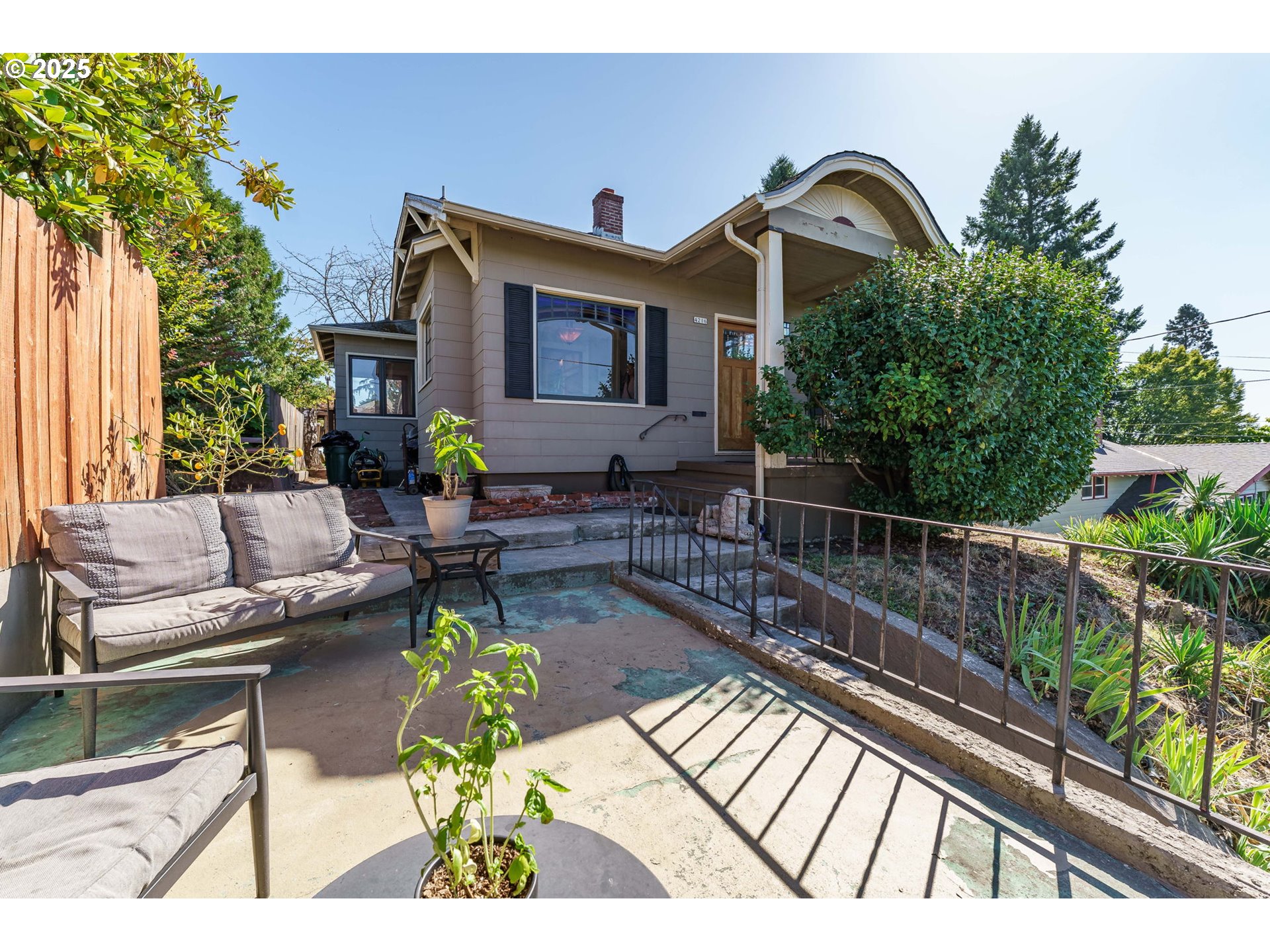 4216 Northeast 18th Avenue Portland, OR 97211 - Photo 34 of 46 a view of a balcony with chairs potted plants with wooden floor and fence