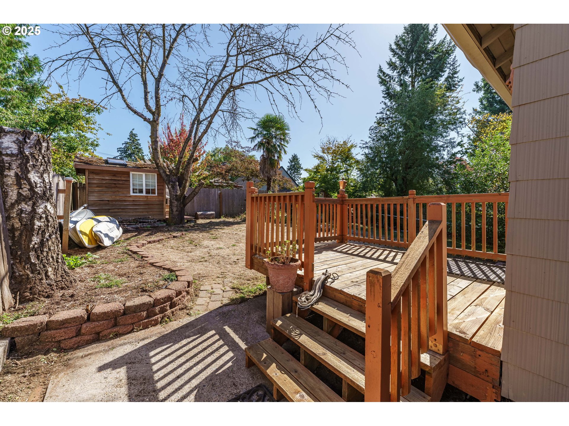 4216 Northeast 18th Avenue Portland, OR 97211 - Photo 35 of 46 a view of a wooden deck with chairs and a fire pit