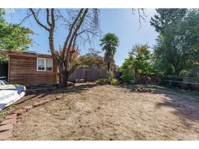 a backyard of a house with barbeque oven
