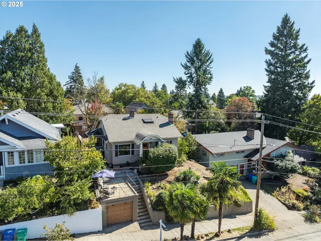 an aerial view of a house with a yard and garden