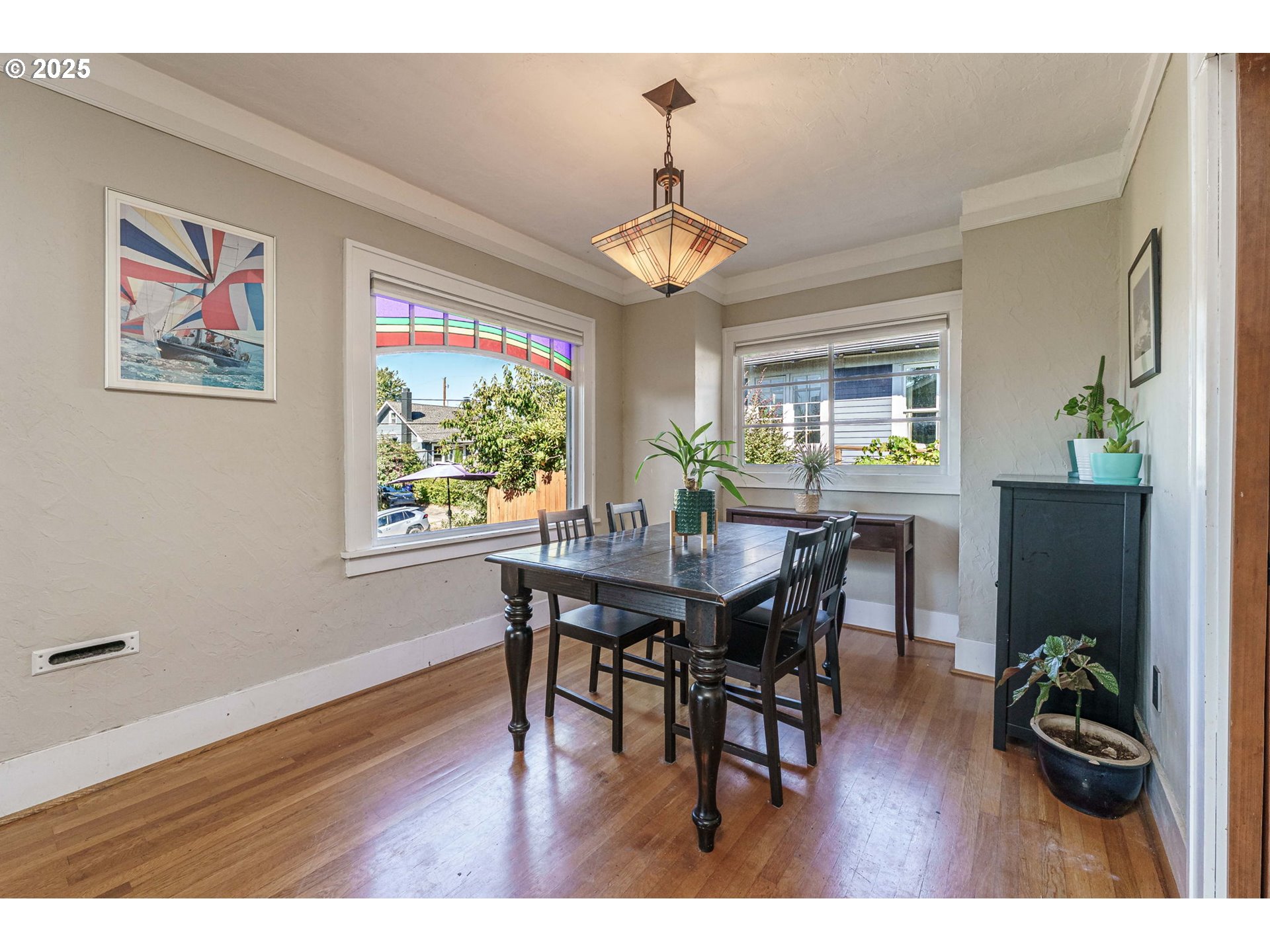 4216 Northeast 18th Avenue Portland, OR 97211 - Photo 9 of 46 a view of a dining room with furniture window and wooden floor