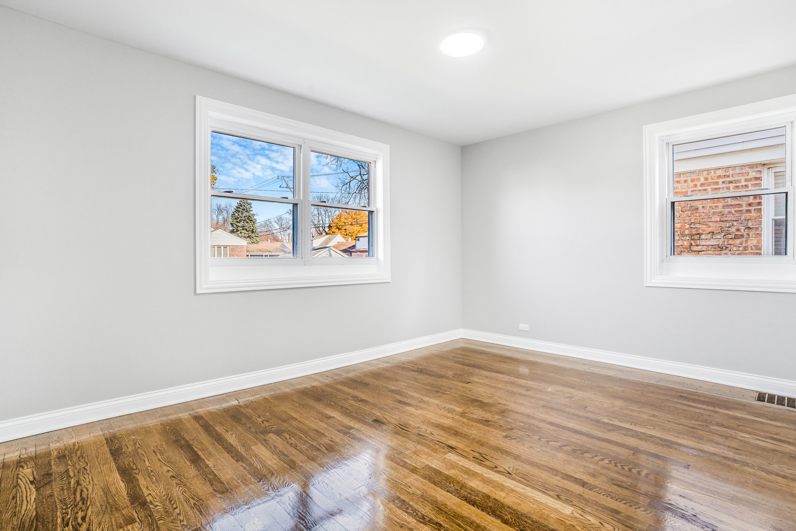 3519 West 80th Street Chicago, IL 60652 - Photo 9 of 22 a view of an empty room with wooden floor and a window
