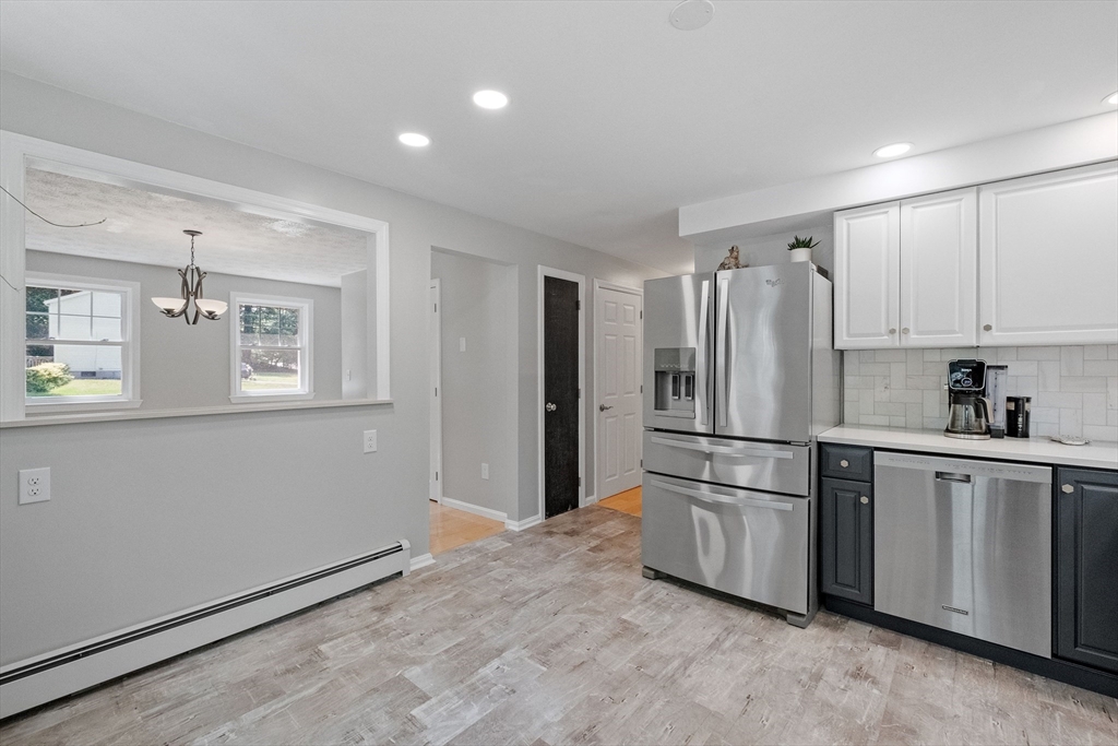 54 Alpine Street Milford, NH 03055 - Photo 11 of 33 a kitchen with stainless steel appliances a refrigerator sink and microwave
