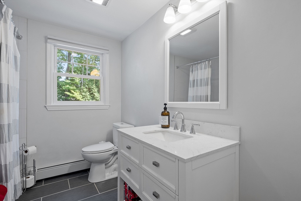 54 Alpine Street Milford, NH 03055 - Photo 14 of 33 a bathroom with a sink toilet and mirror