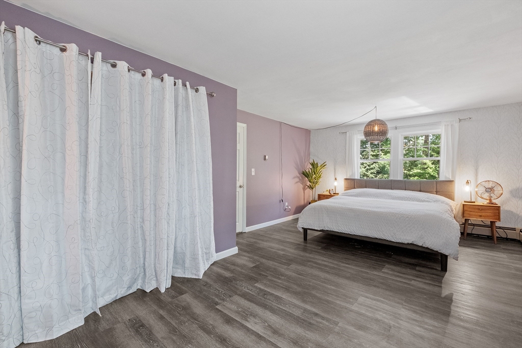 54 Alpine Street Milford, NH 03055 - Photo 16 of 33 a spacious bedroom with a bed and a window