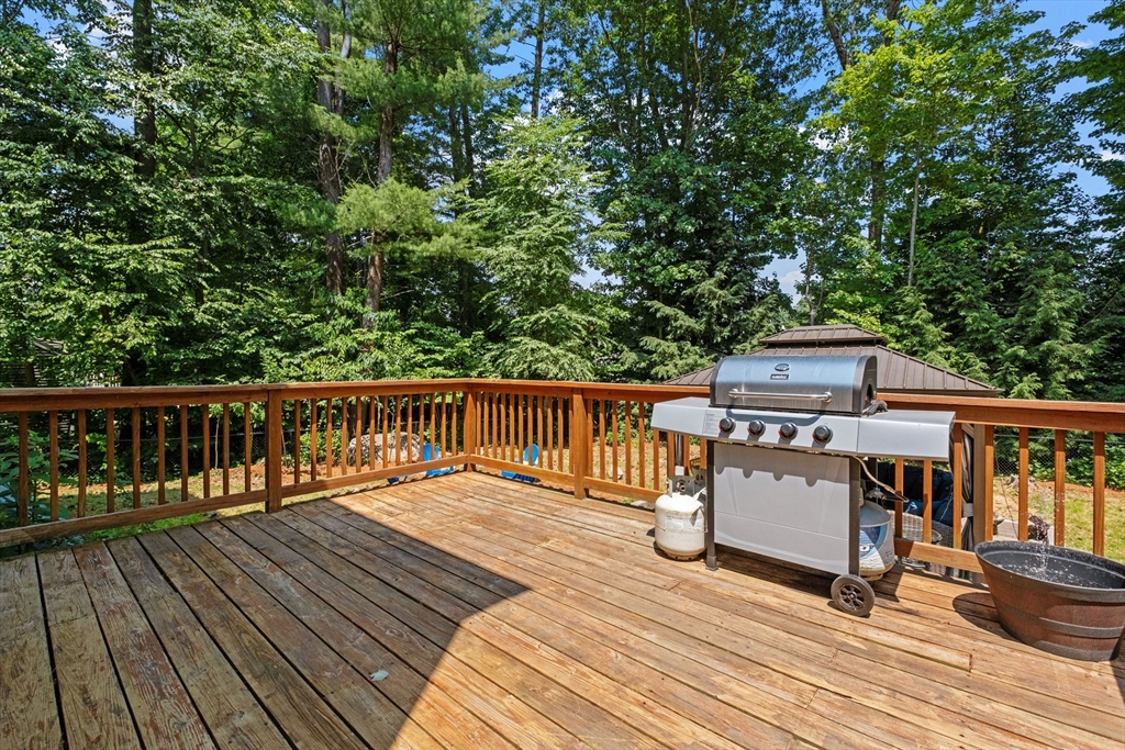 54 Alpine Street Milford, NH 03055 - Photo 24 of 33 a balcony with wooden floor table and chairs