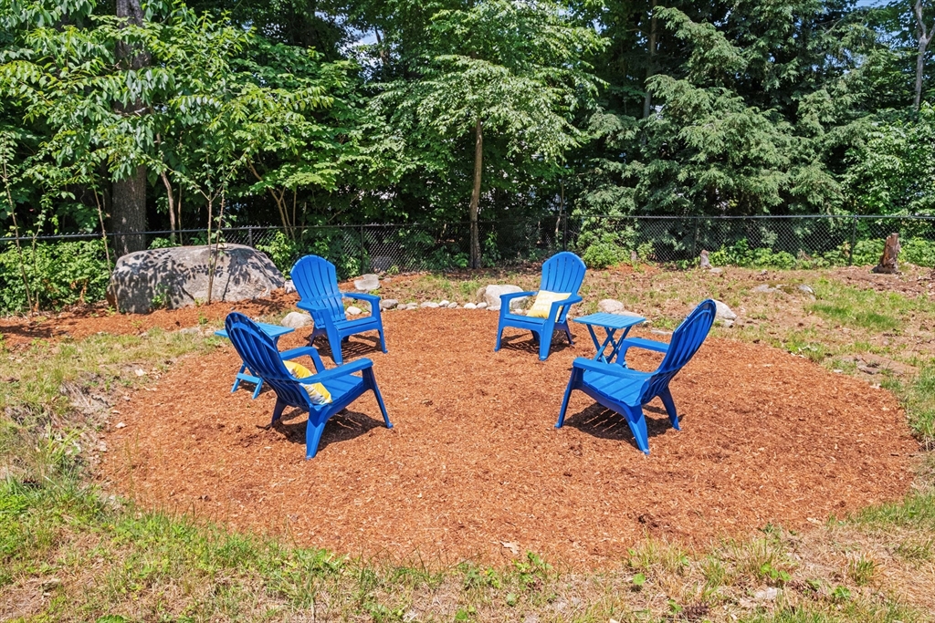 54 Alpine Street Milford, NH 03055 - Photo 28 of 33 a bench sitting in the middle of a yard
