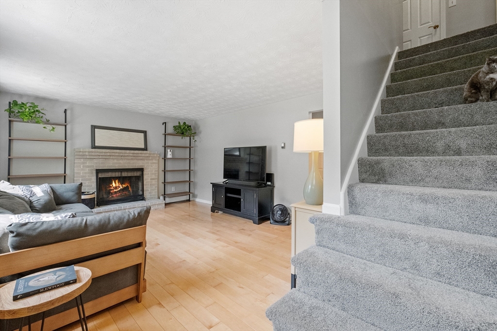 54 Alpine Street Milford, NH 03055 - Photo 4 of 33 a living room with furniture and a fireplace
