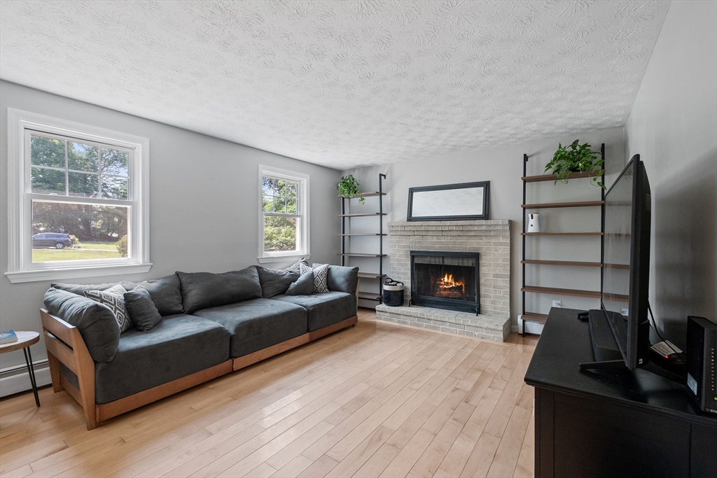 54 Alpine Street Milford, NH 03055 - Photo 5 of 33 a living room with furniture and a fireplace