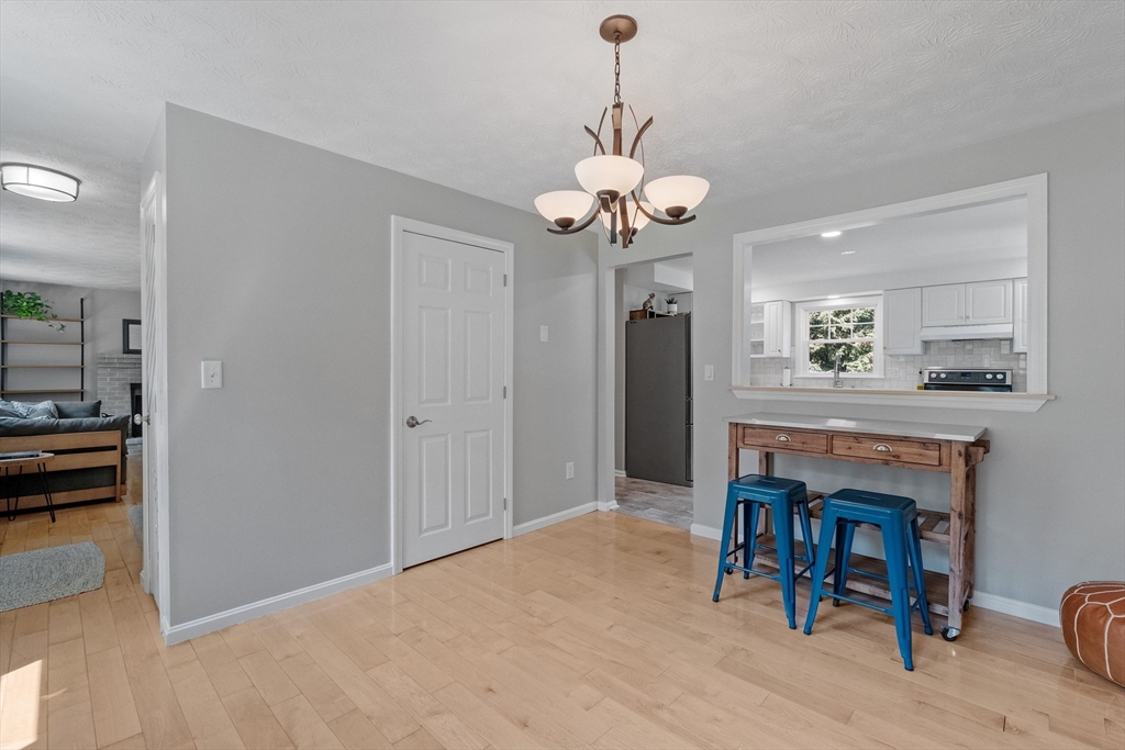 54 Alpine Street Milford, NH 03055 - Photo 7 of 33 a view of a dining room with furniture and a chandelier