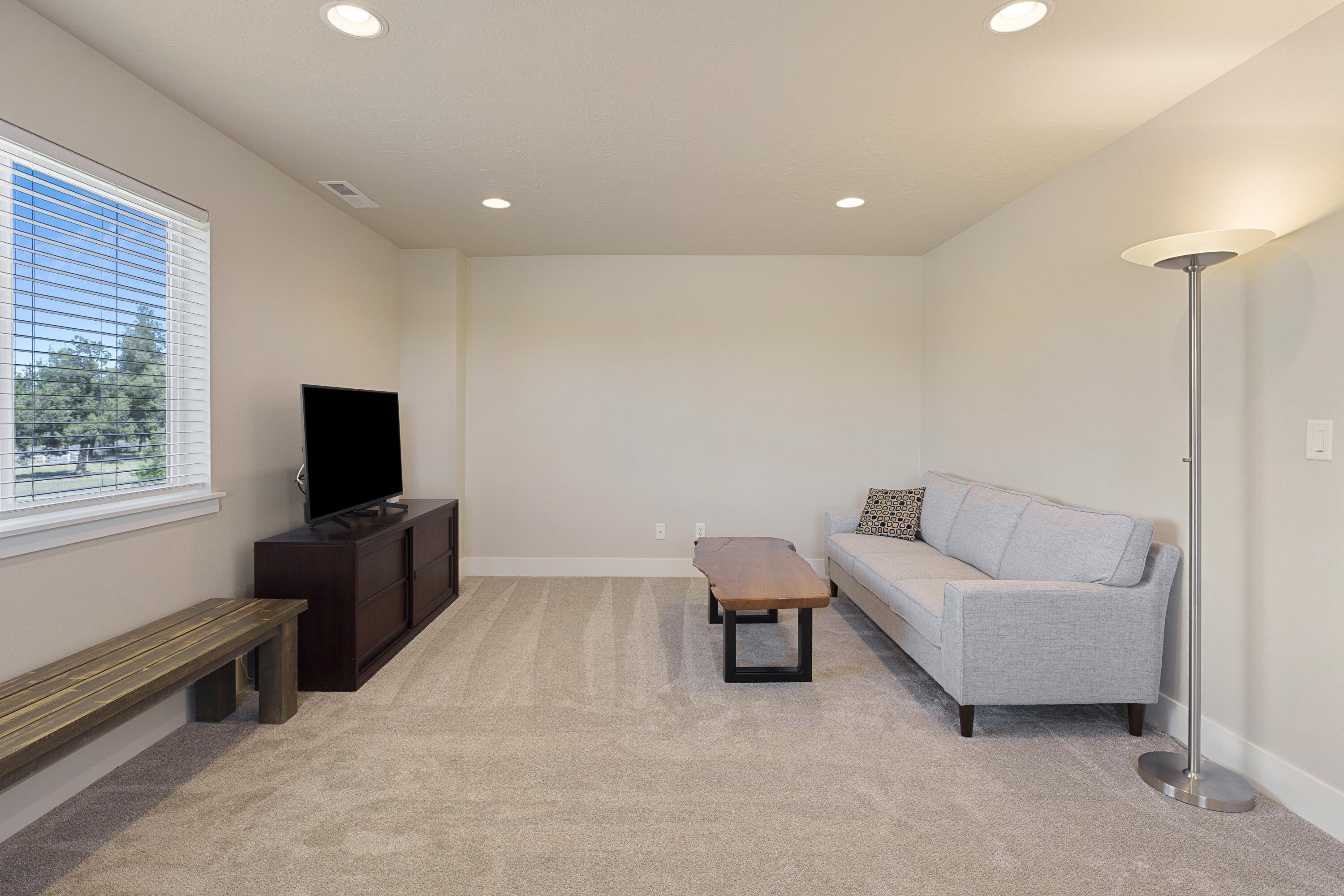 4999 Southwest Yew Place Redmond, OR 97756 - Photo 27 of 50 a living room with furniture and a flat screen tv