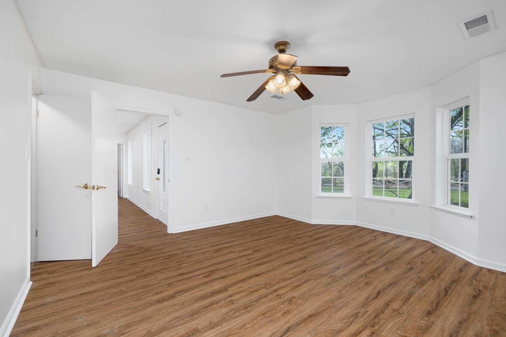 1388 Double Bridges Road Munford, TN 38058 - Photo 11 of 31 a view of empty room with wooden floor and window