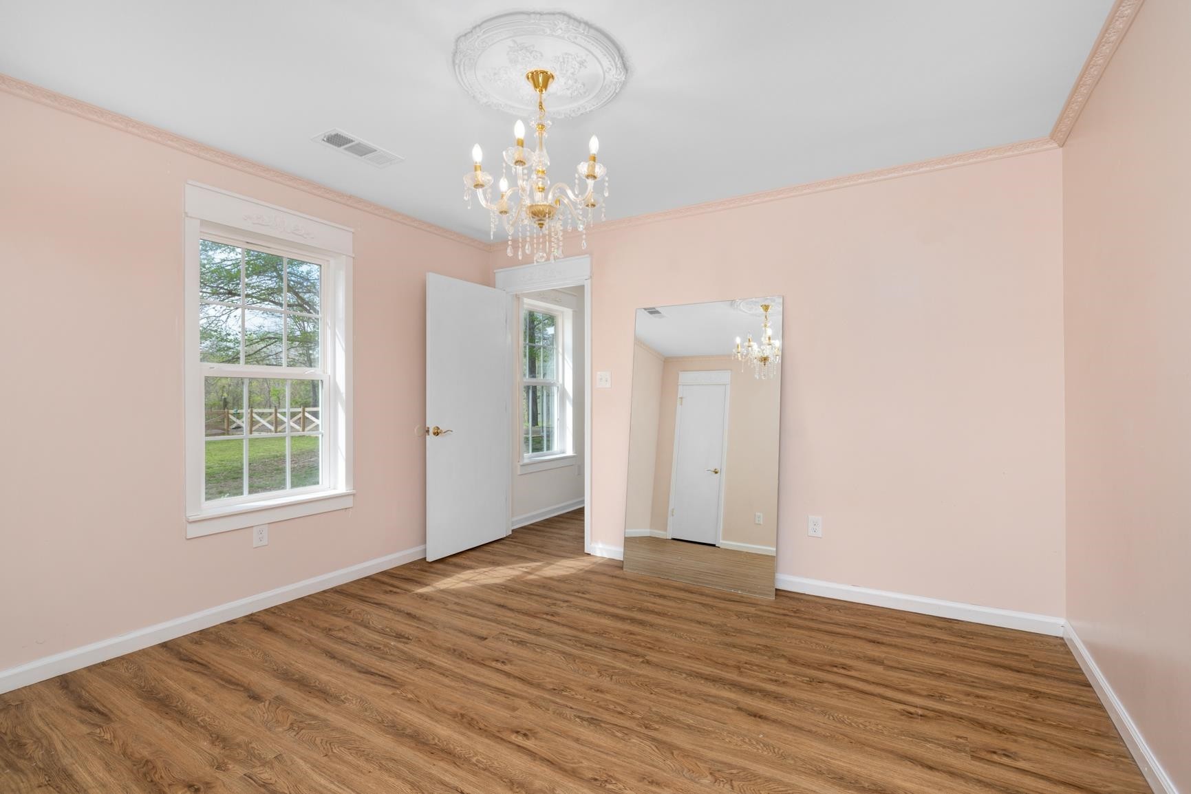 1388 Double Bridges Road Munford, TN 38058 - Photo 17 of 31 a view of an empty room with wooden floor and a window