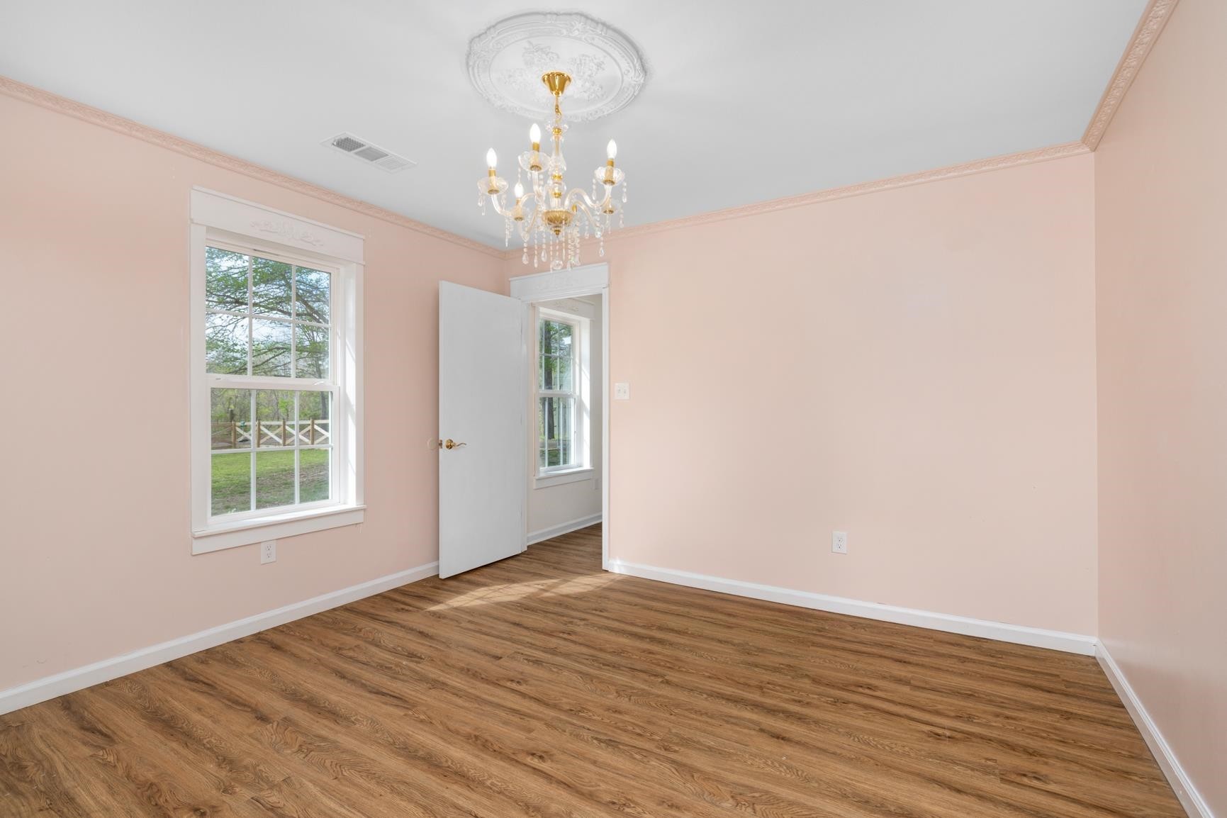 1388 Double Bridges Road Munford, TN 38058 - Photo 18 of 31 a view of an empty room with wooden floor and a window