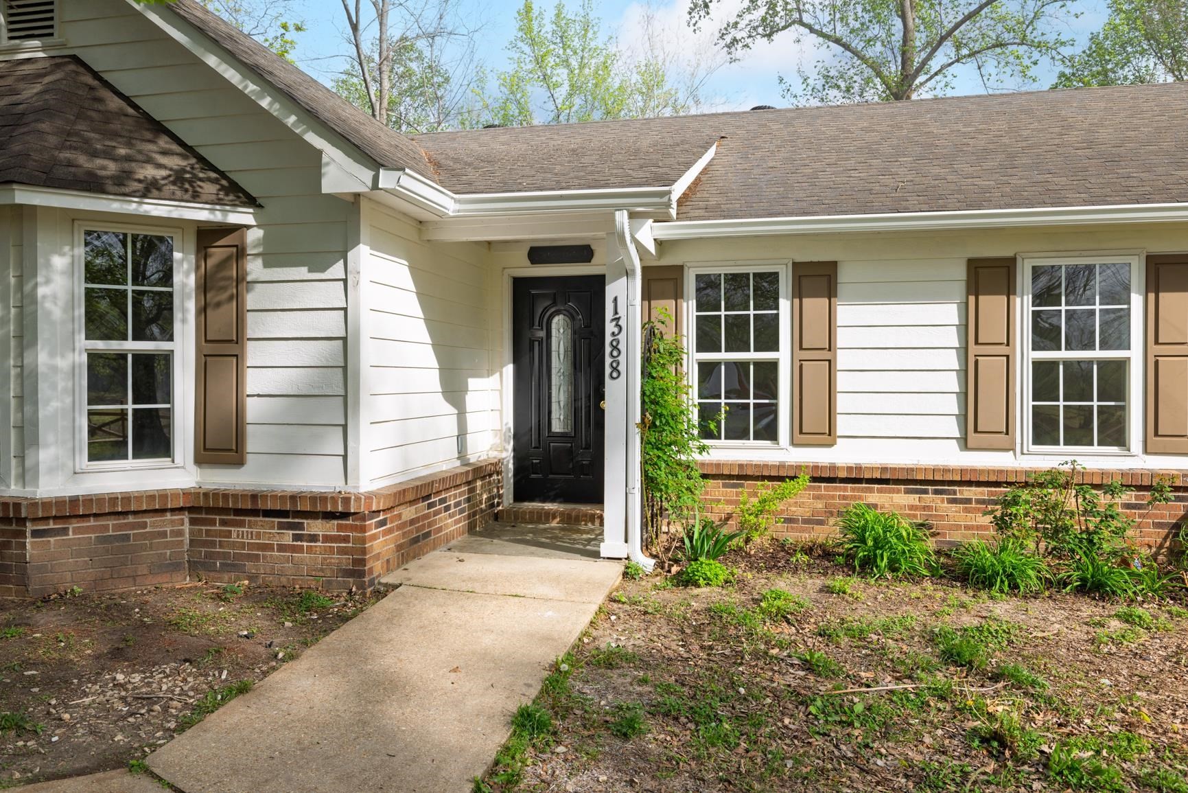 1388 Double Bridges Road Munford, TN 38058 - Photo 2 of 31 a front view of a house with a yard and garage
