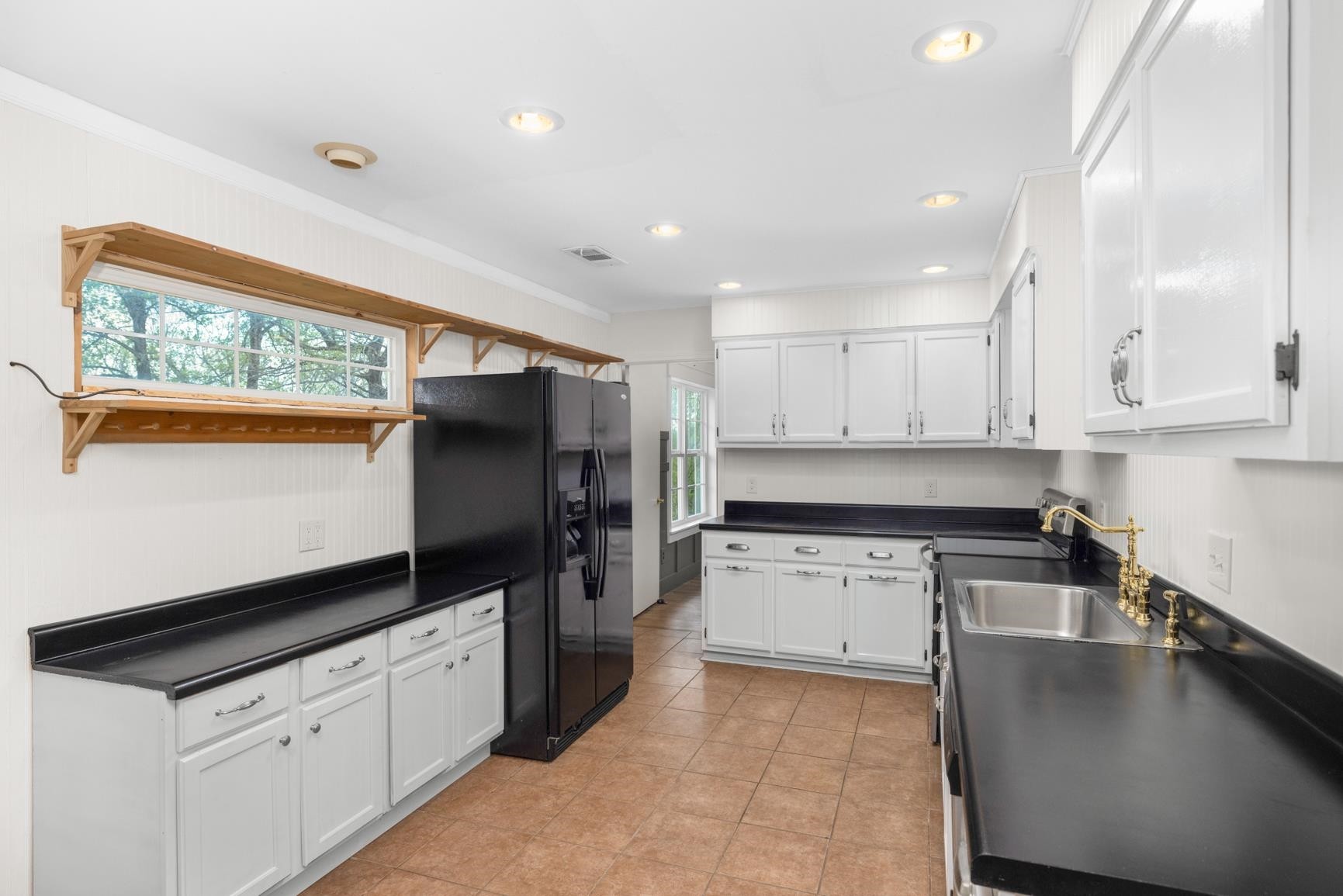 1388 Double Bridges Road Munford, TN 38058 - Photo 7 of 31 a kitchen with granite countertop a stove sink and refrigerator