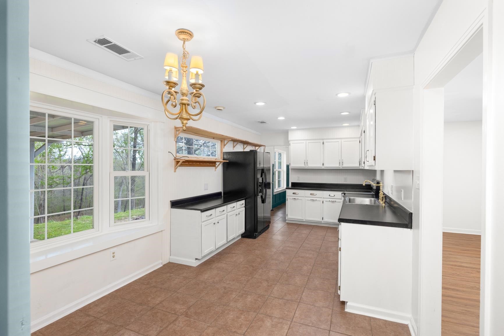 1388 Double Bridges Road Munford, TN 38058 - Photo 8 of 31 a kitchen with stainless steel appliances granite countertop a sink and a refrigerator