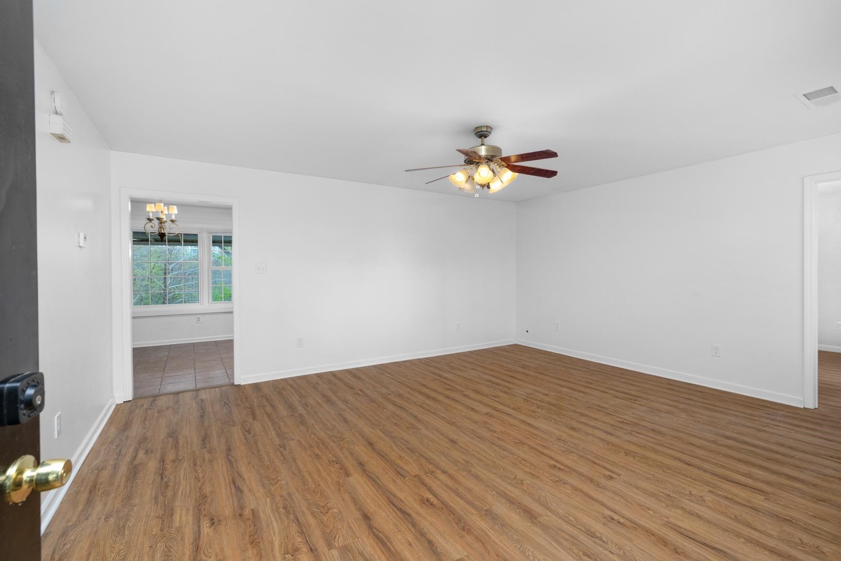 1388 Double Bridges Road Munford, TN 38058 - Photo 10 of 31 a view of empty room with wooden floor