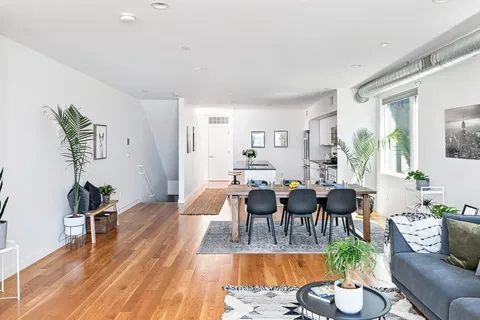 a view of a dining room with furniture window and wooden floor