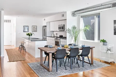 a view of a dining room with furniture and wooden floor