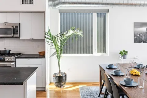 a kitchen with a table and chairs in it