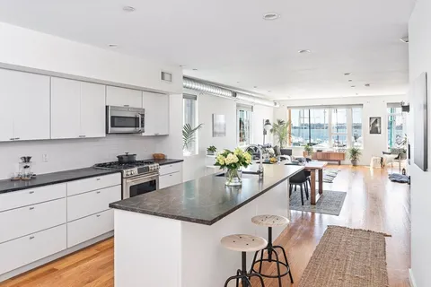 a kitchen with sink a stove and cabinets