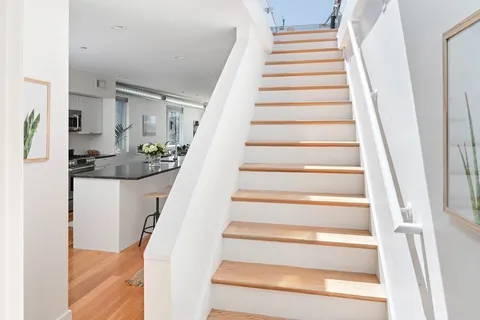 a view of staircase with white walls