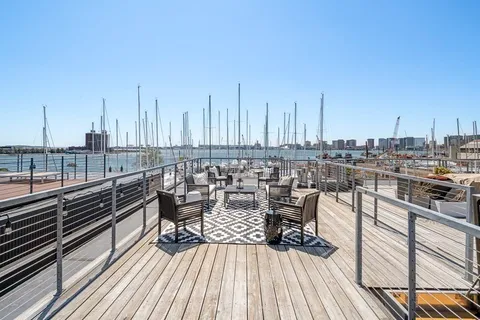 a view of a balcony with chairs and wooden floor