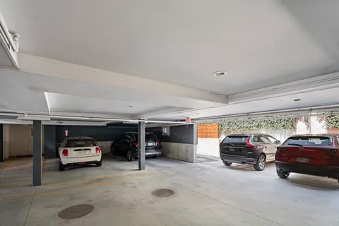 a view of parking garage with cars parked