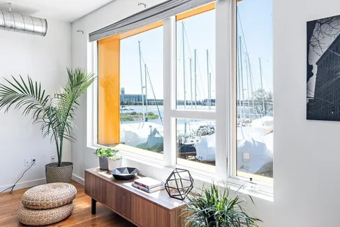 a living room with furniture and a floor to ceiling window