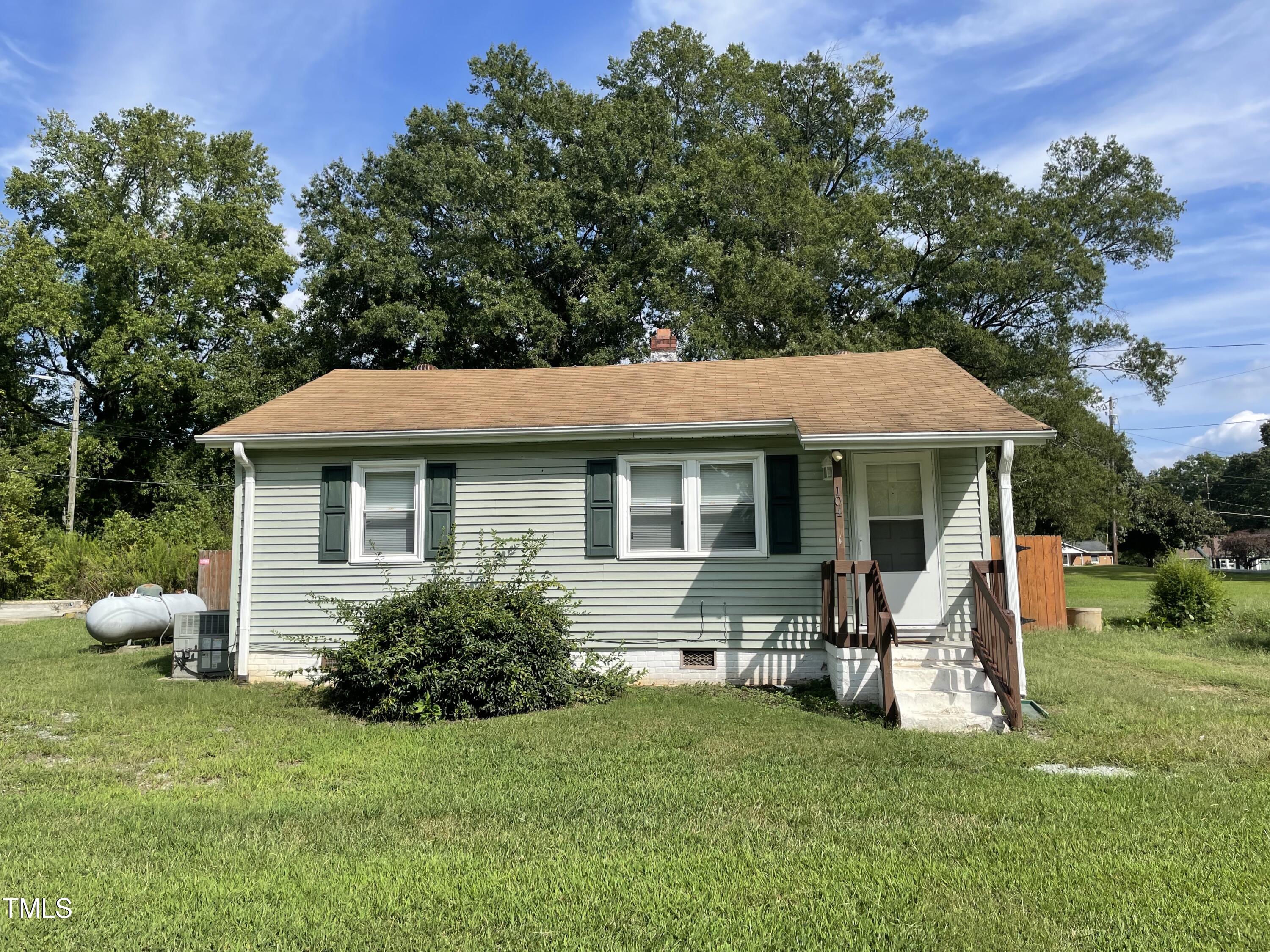 a view of a house with backyard sitting area and garden