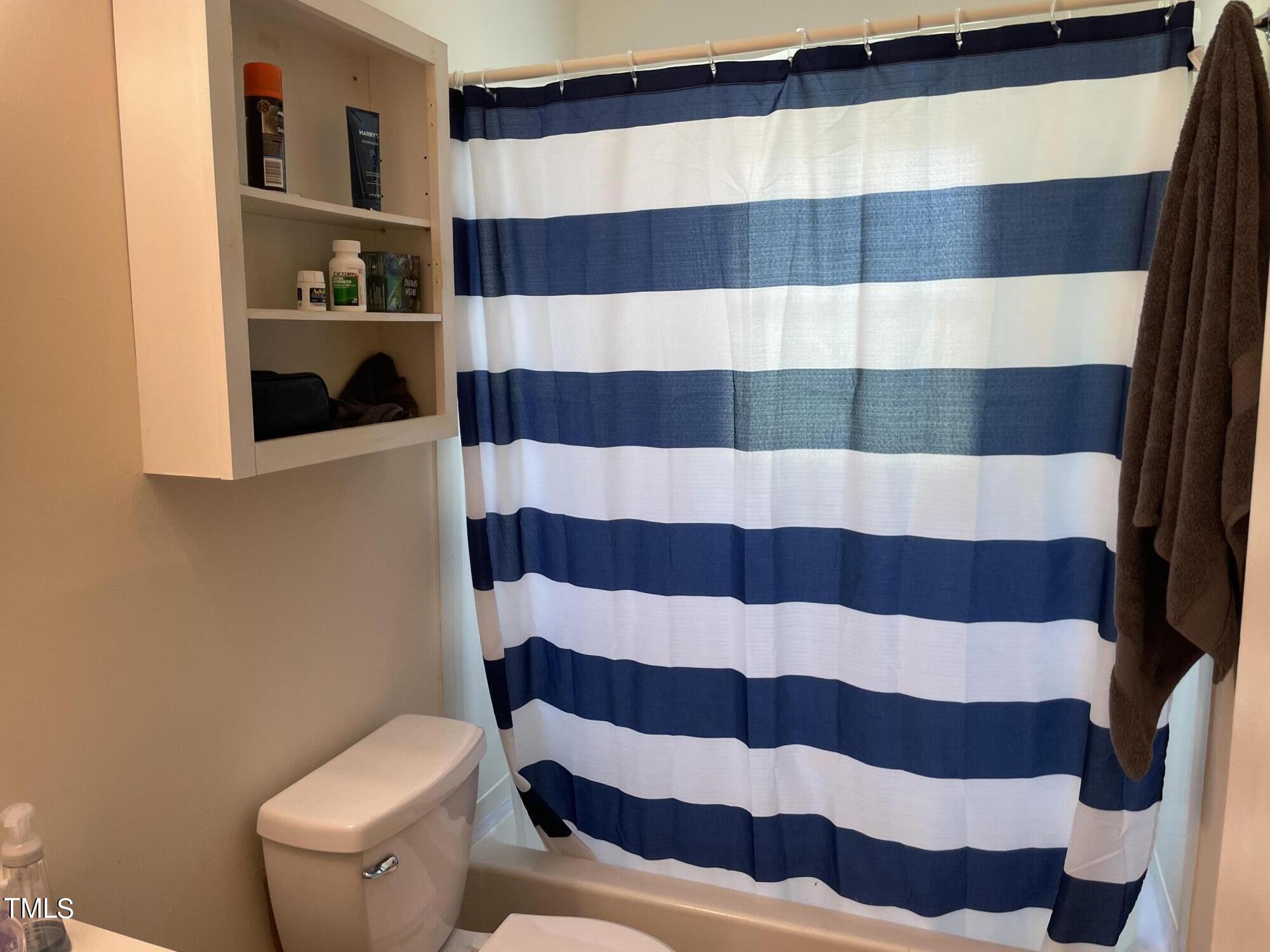 104 Summers Drive Elon, NC 27244 - Photo 7 of 11 a bathroom with a toilet and a shower curtain